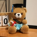 Ours en peluche diplômé marron en robe satin bleu clair avec écharpe de félicitations - Ours Brun Foncé-Vêtements Bleu Ciel / 18cm