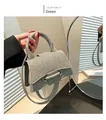 Detail of green woven small square bag with cylindrical handle and hourglass base design - Green