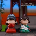 Ancient Chinese style resin figurines of a couple in traditional red and green attire - Chiyu Ornament (1188-8A)