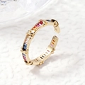Macro detail of gold open ring featuring rainbow baguette-cut gemstones and twisted metal - Twisted Rainbow Design / Gold Gradient Rainbow