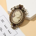 Detail of vintage cameo brooch with antique gold hollow frame and red crystal accents - Style 6 (Beige Cameo/Antique Gold/Red Gemstone)
