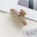 Detail of beige acetate hair claw clip with lime green edge and golden letter B logo - Gold B Logo / Pink and Green