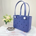 Detail view of navy blue EVA beach bag with perforated holes and white strap fasteners - Small / Navy Blue