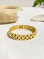 Detailed close-up of 18K gold watch band style bracelet with white pearl inlays - Gold