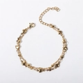 Detailed view of golden double-layer chain bracelet with heart charms and beads - 17+5cm / Cross Bead Chain + Vertical Double Heart Bracelet / Gold
