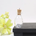 Mini pear-shaped clear glass bottle with cork stopper and silver pendant loop for DIY crafts - Transparent Oval Bottle With Eye Screw Cork