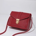 Crossbody red pebble leather bag with white contrast stitching and gold metal buckle - Red