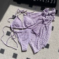 Three-piece lavender seersucker bikini set with halter top, side-tie bottoms and mesh skirt - Violet