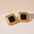 Macro shot of square gold earrings with black enamel inlay on white display stand - Silver Needle Black Square Stud Earrings