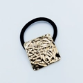 Elegant black hair tie featuring a square gold alloy charm with textured relief design - Square Abstract Relief (Hair Tie 84)