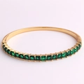 Close-up of 18K gold-plated bangle with square emerald-cut green cubic zirconia stones - Green Zirconia