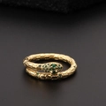 Macro view of gold-plated snake ring with green zircon eyes and scaled texture details - Gold Snake Head Green Gem Style