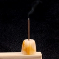 Yellow jade incense holder in lantern shape with burning stick on wood base - Topaz