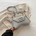 Elegant silver sequin evening bag with a bow and chain strap, perfect for formal events - Silver