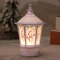 Detail of white Christmas lantern with snowman prints and warm glowing LED light inside - White Snowman