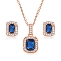 Macro detail of rose gold jewelry set featuring square blue stones and micro-pave crystals - Rose Gold + Royal Blue Stone Set