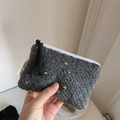 Detail of grey knitted coin purse with colorful flecks and a white zipper closure - Dark Gray