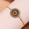Close-up of gold snake chain bracelet featuring a turquoise and zircon evil eye charm - Turquoise Evil Eye Style (Style 2)