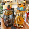 Minimalist clear plastic sports bottle with yellow and orange caps and carry strap - Orange and Grey