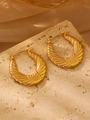 Golden textured hoop earrings with shell wing pattern on a minimalist stone background - 18K Gold Twill (0584)