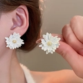 Close-up of daisy earrings with white petals and golden stamen on a model ear - 50# White Daisy Gold Stamen Stud Earrings (HE15735)
