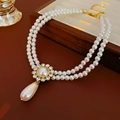 Detail of double-layer pearl necklace with rhinestone flower and teardrop pearl pendant - Necklace - Gold