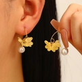 Elegant osmanthus flower earrings with pearls shown worn on a model for a gentle look - Yellow Flower Bottom Artificial Pearl Style (1199) / Faux Pearl