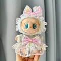 Labubu doll wearing a green plush hoodie with pink bows and colorful fringe skirt - Pink Tassel Lace Skirt / First And Second Generation Keychains Are Compatible With La Cloth Dolls. Dolls Not Included.