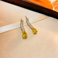 Detailed macro view of pear-cut yellow gemstone earrings with sparkling zircon inlay - Yellow Rhinestone Water Drop Stud Earrings