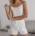 Close-up of white heart-shaped hollow knit fabric and decorative buttons on sleepwear - White