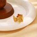 Gold hollow floral stainless steel open ring with matte textured petals on a ceramic tray - Hollow Flower Style