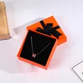 Rose gold necklace with red enamel pendant inside a minimalist orange gift box - 9x9x4cm / Orange
