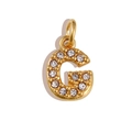 Detailed view of a gold-plated letter G pendant featuring sparkling white crystals - Letter G / Gold