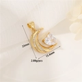 Macro view of 14K gold moon and heart zircon pendant measuring 23mm by 15.4mm - Heart Moon