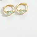 Golden hoop earrings with green teardrop enamel and clear gemstones on white leather - Green