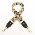 Detail of adjustable geometric diamond pattern wide canvas strap with gold metal hooks - No.4 Green Coffee Jacquard + Black Leather