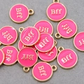 Macro shot of rose pink round oil drip charms with gold edges and Bff engraving for DIY - Rose Pink