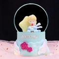 Blue Little Prince musical snow globe with white wings and pink roses on decorative base - Large 100mm Snow + Light / Light Blue