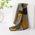 Green houndstooth silk scarf featuring yellow floral patterns on a white display cube - Green Houndstooth