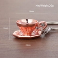 Rose gold 3D coffee cup keychain in metal alloy finish on dark wood surface - Cup with Saucer (Rose Gold)