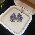 Macro shot of silver bow earrings with purple teardrop crystals in a velvet box - 2# Ear Buckle Silver Purple Teardrop Gem
