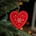 Red heart wooden Christmas pendant with snowflake pattern hanging on a festive tree branch - Red Heart Pendant