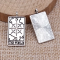 Macro view of vintage silver The World tarot card pendant on rustic wood and linen - Antique Silver THE WORLD