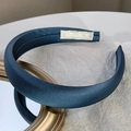 Detail of blue satin padded headband resting on gold frame with professional lighting - Blue Gold