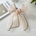 Elegant beige organza hair bow ribbon with black stitched edges and soft draping style - Light Orange