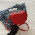 Chic red heart-shaped crossbody bag made of PU leather with elegant golden hardware - Red