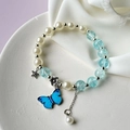 Elegant pearl and sea blue bead bracelet with butterfly charm on a ceramic tray - S013-light Blue Butterfly Pendant Pearl Burst Pattern Bracelet #sz152
