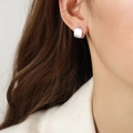 Minimalist square geometric earrings in matte silver finish shown on a model - Square Style / 1.1x0.9cm / Silver