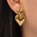 Golden double heart drop earrings in 18k gold plated stainless steel on model - Gold