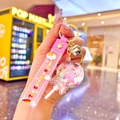 Pink lollipop oil-filled shaker keychain with silicone wristlet and small bell - White Luminous Lollipop